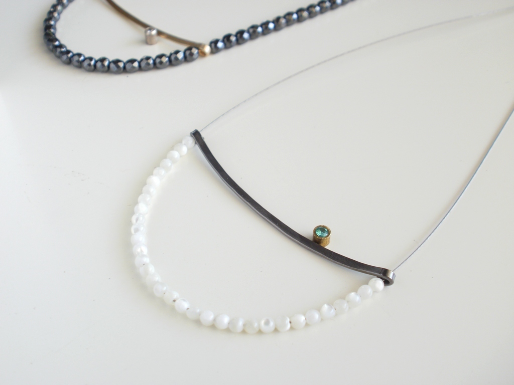 Necklace with morher of pearl, oxidized silver, goldplated silver, zircon, steel wire.